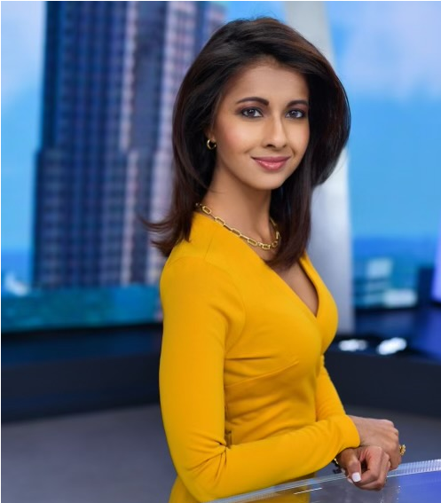 Jasmine Huda wearing a yellow dress.